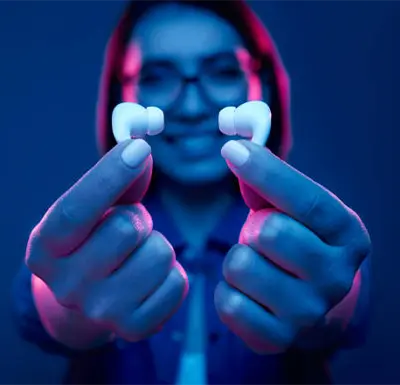Model holding TWS Bluetooth headphones in hand
